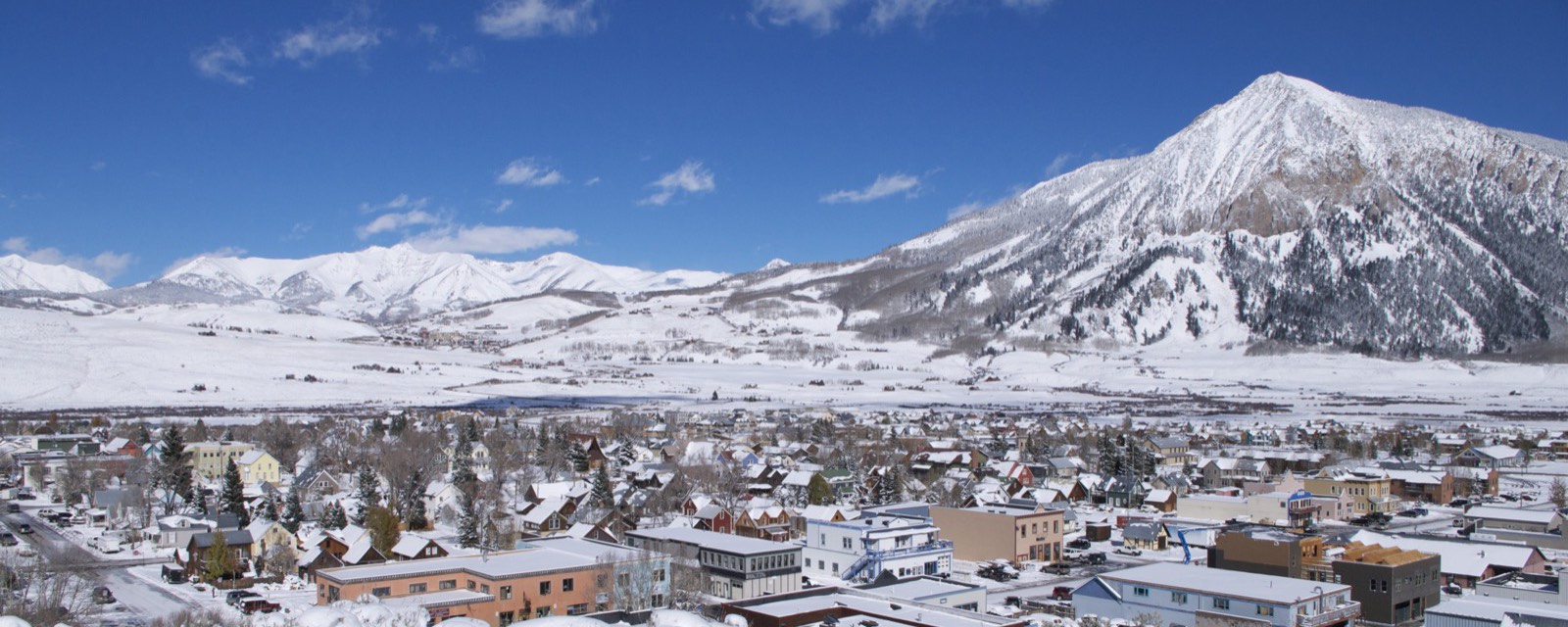 Crested Butte town under snow with Mt. Crested Butte behind